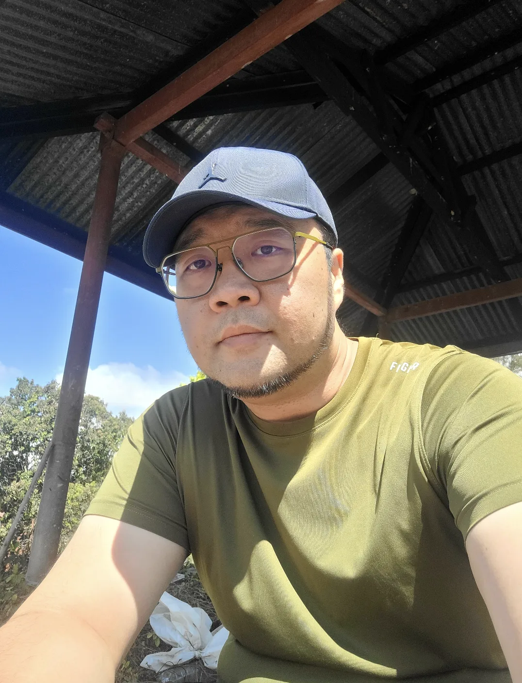 Selfie under the metal-roofed shelter at the cemetery