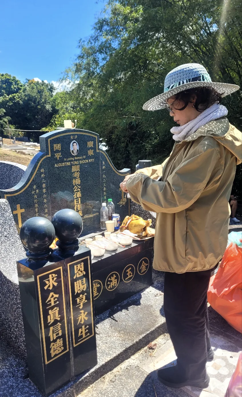 Mum at the grave with offerings