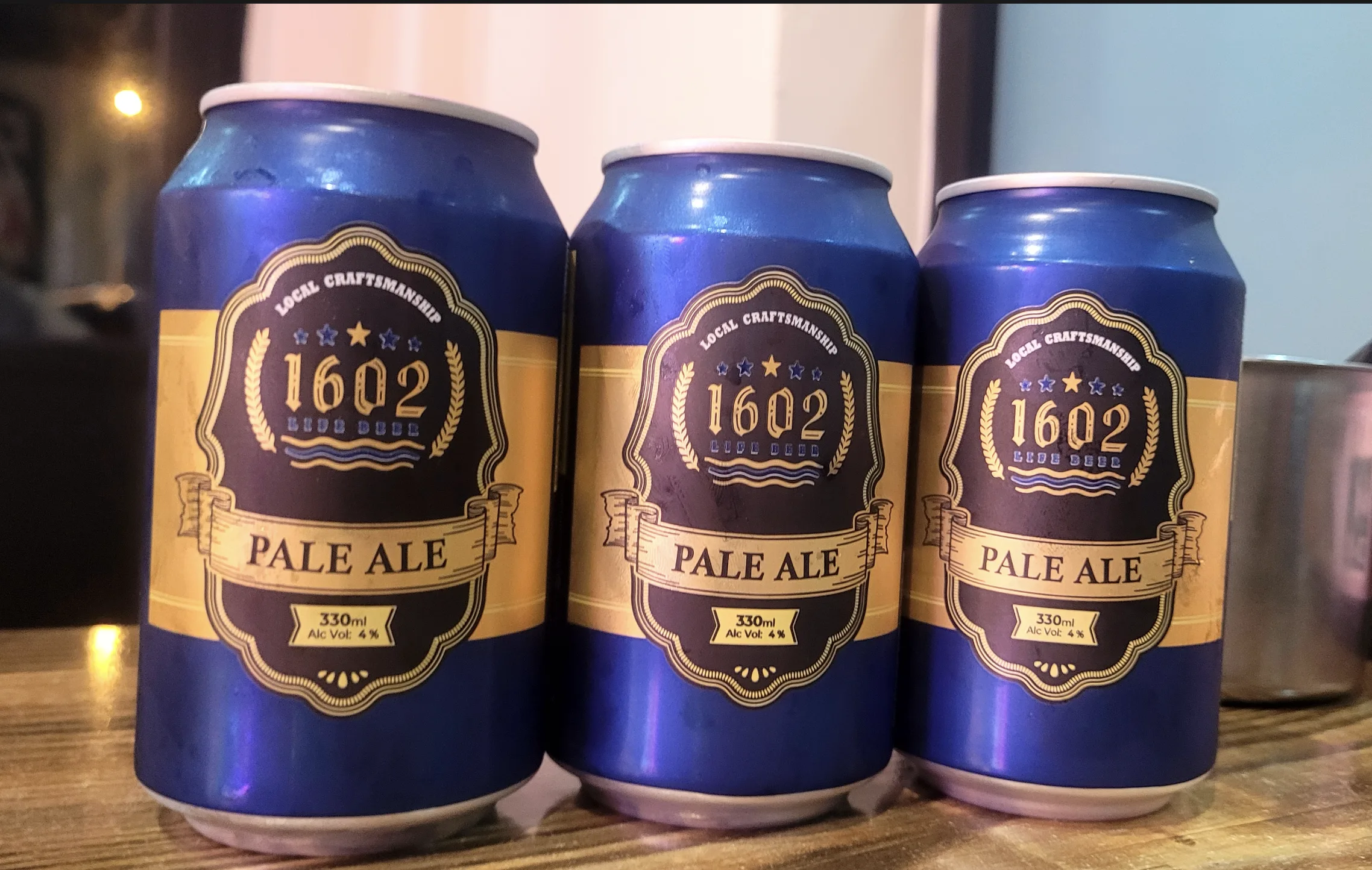 Three cans of 1602 Pale Ale
