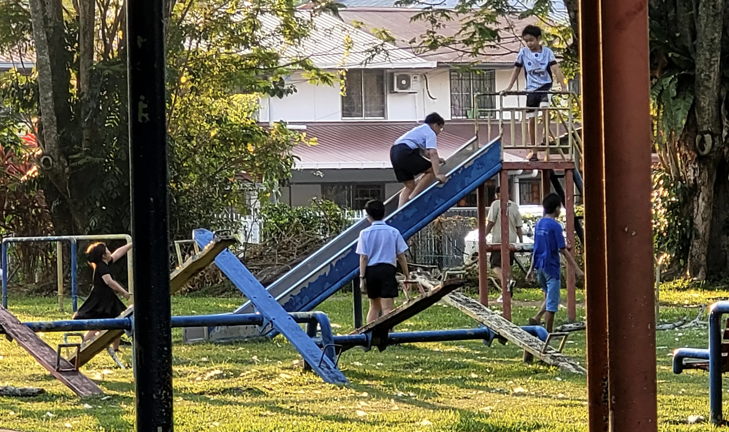 Kids playing on the slide and seesaw