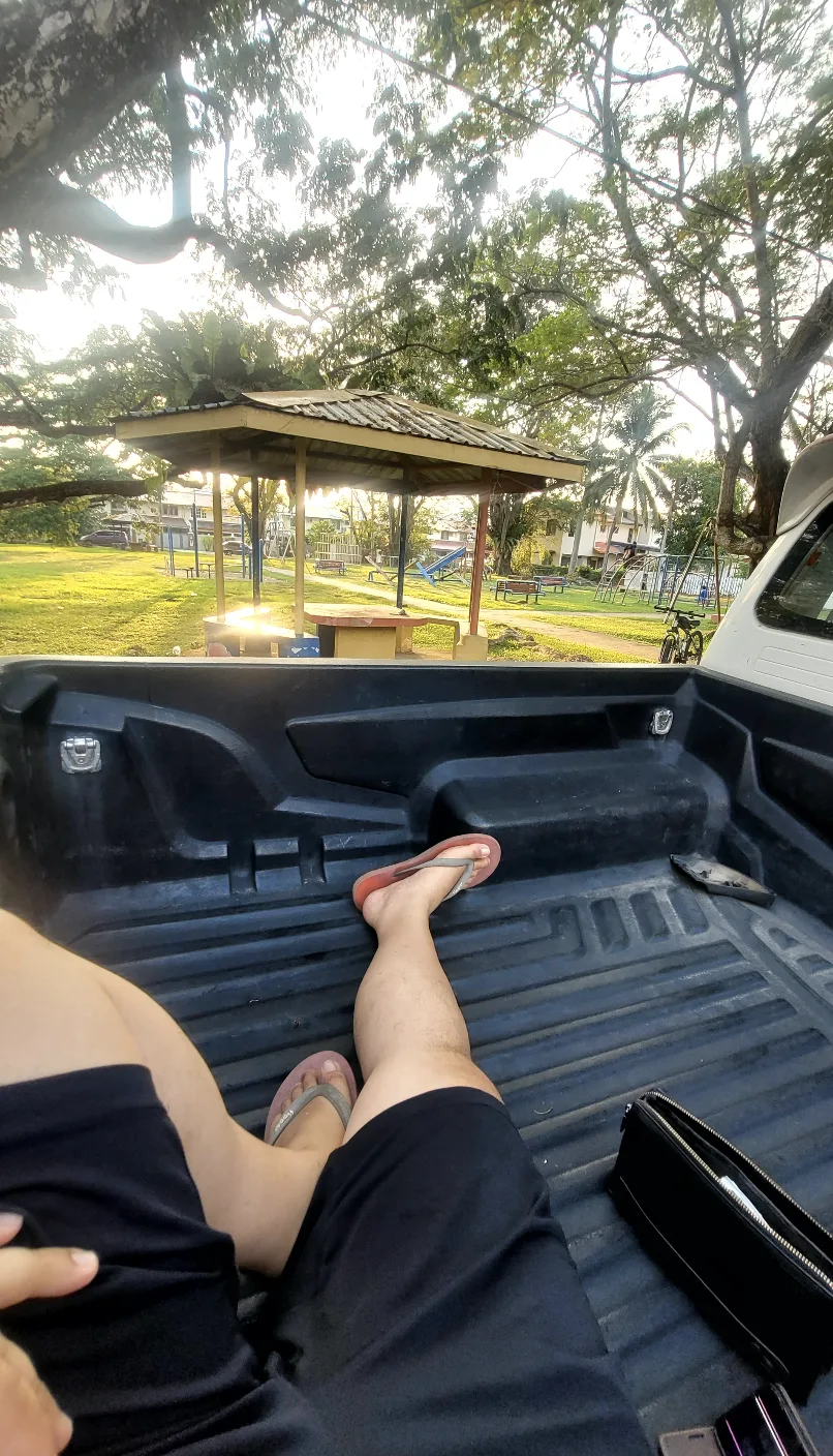 Feet up in the pickup bed at the neighbourhood padang