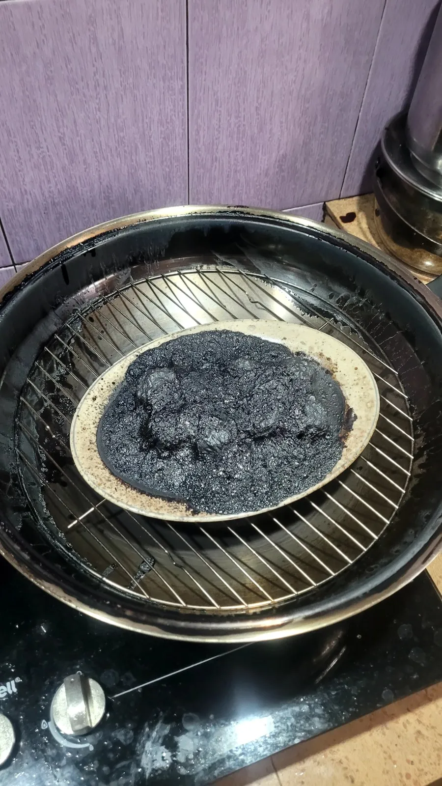 A steamer pot burnt completely black