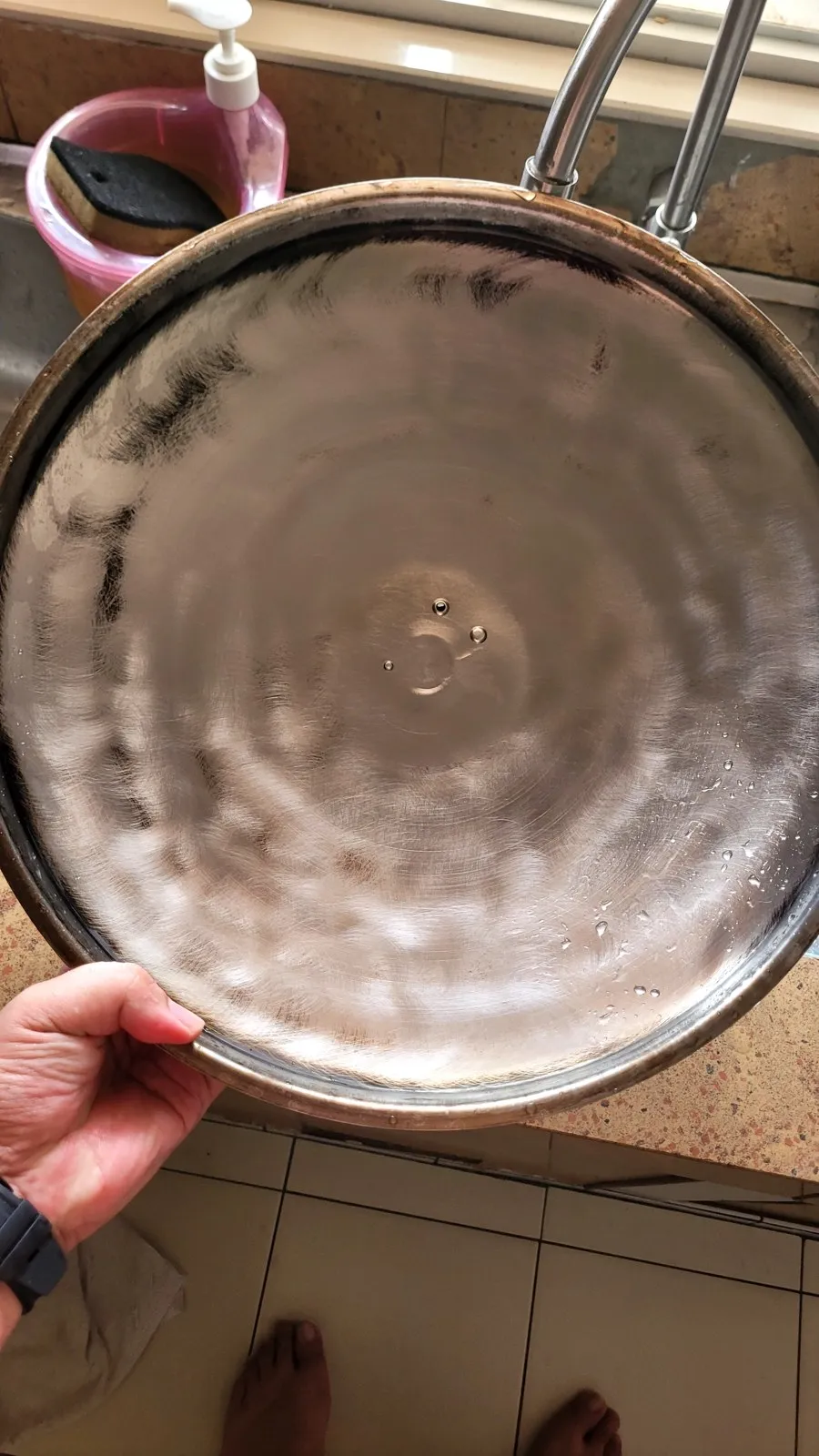 The same pot, scrubbed back to shiny steel