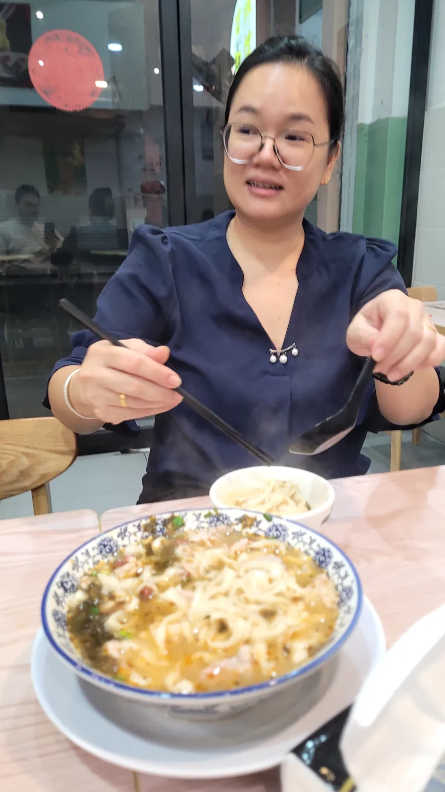 My wife at dinner, about to eat
