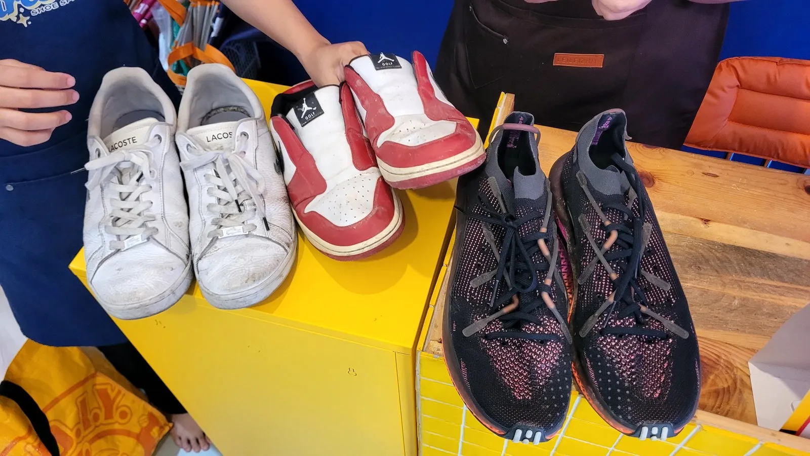 Three pairs of sneakers on a shop counter